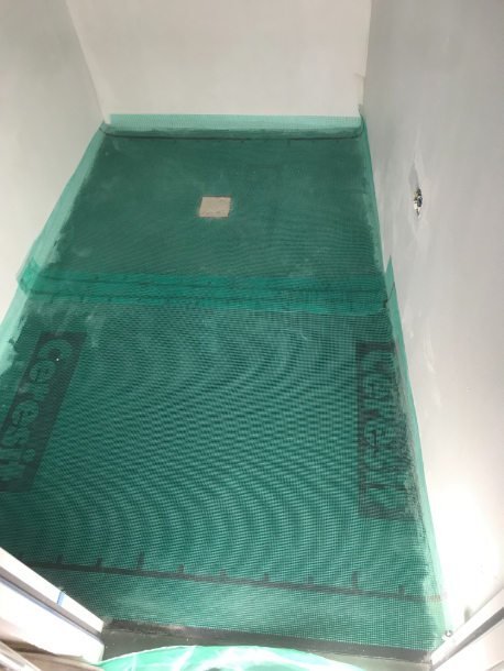 Pose de la trame en fibre au sol d'une douche à l'italienne